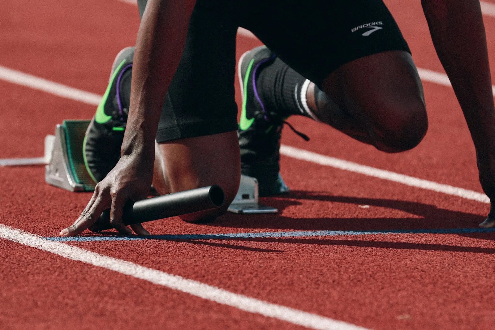 Runner in starting blocks preparing to sprint