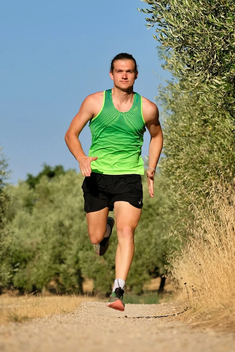 Runner clutching lower leg in pain after a calf strain